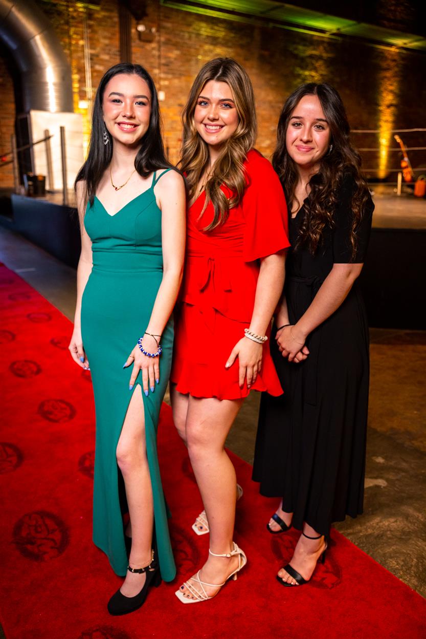 Three young women smile